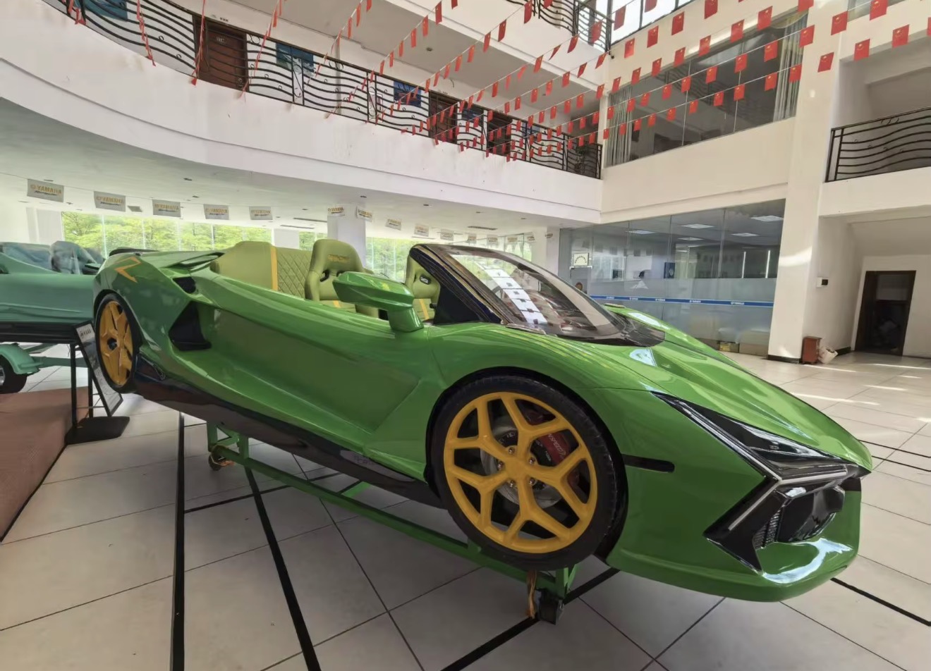 Green Lamborghini-style jet car on the Miami Jet Cars showroom floor with yellow wheels